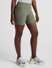 green high-waisted 5" inseam biker shorts  with pockets.