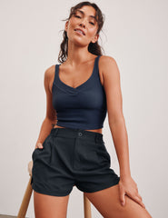 blue ribbed cropped tank top with a soft V neckline front and back​, an overlapping front neckline detail​, and a lining shelf bra​. 