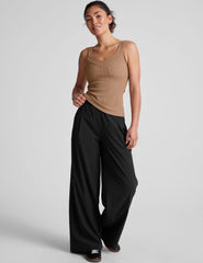 brown classic length tank top with a soft V neckline front and back​, overlapping front neckline detail, and a performance lining shelf bra. Tank hits at a high hip length. 