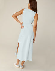 model is wearing a blue tank top maxi dress with a twist detailing and side cutouts.