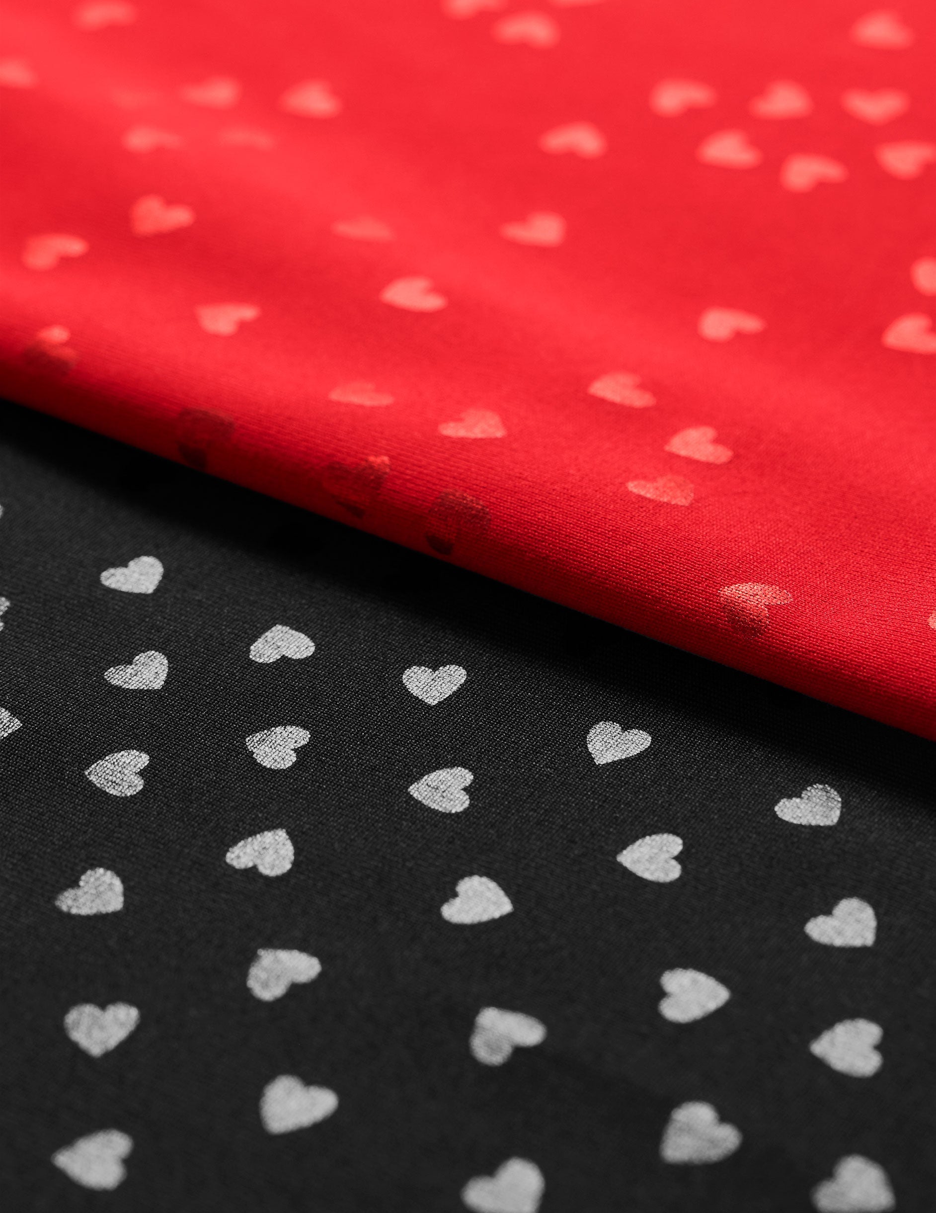 red fabric with a shimmering heart pattern.