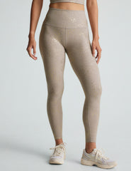 brown high-waisted midi length leggings with a star shine print.