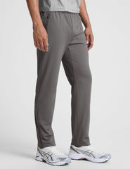 man wearing a gray shirt and gray pants on a white background.