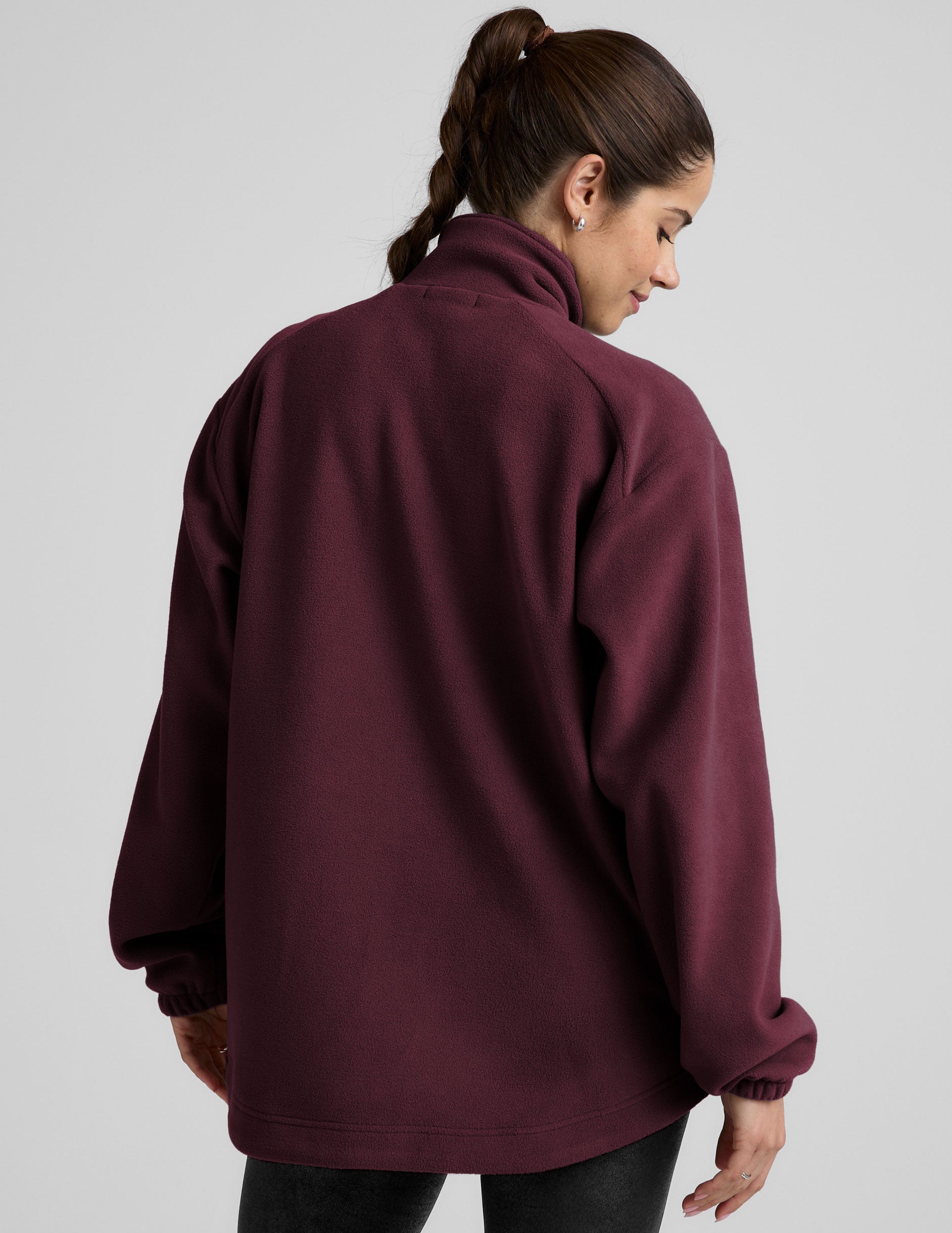 red fleece button up jacket with a full front zip and snap closures and pockets.