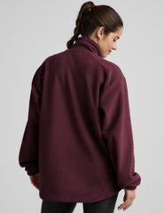 red fleece button up jacket with a full front zip and snap closures and pockets.