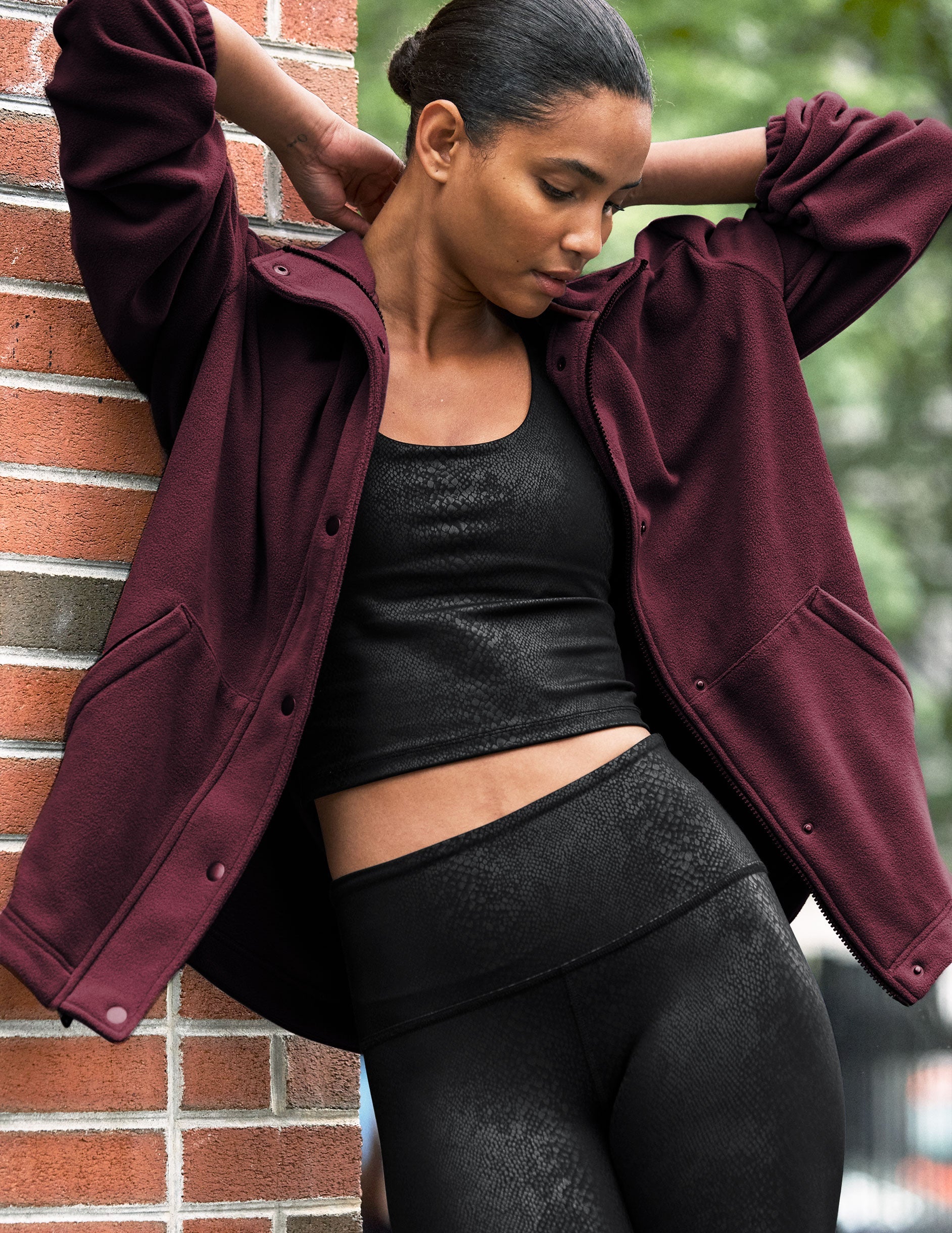red fleece button up jacket with a full front zip and snap closures and pockets.