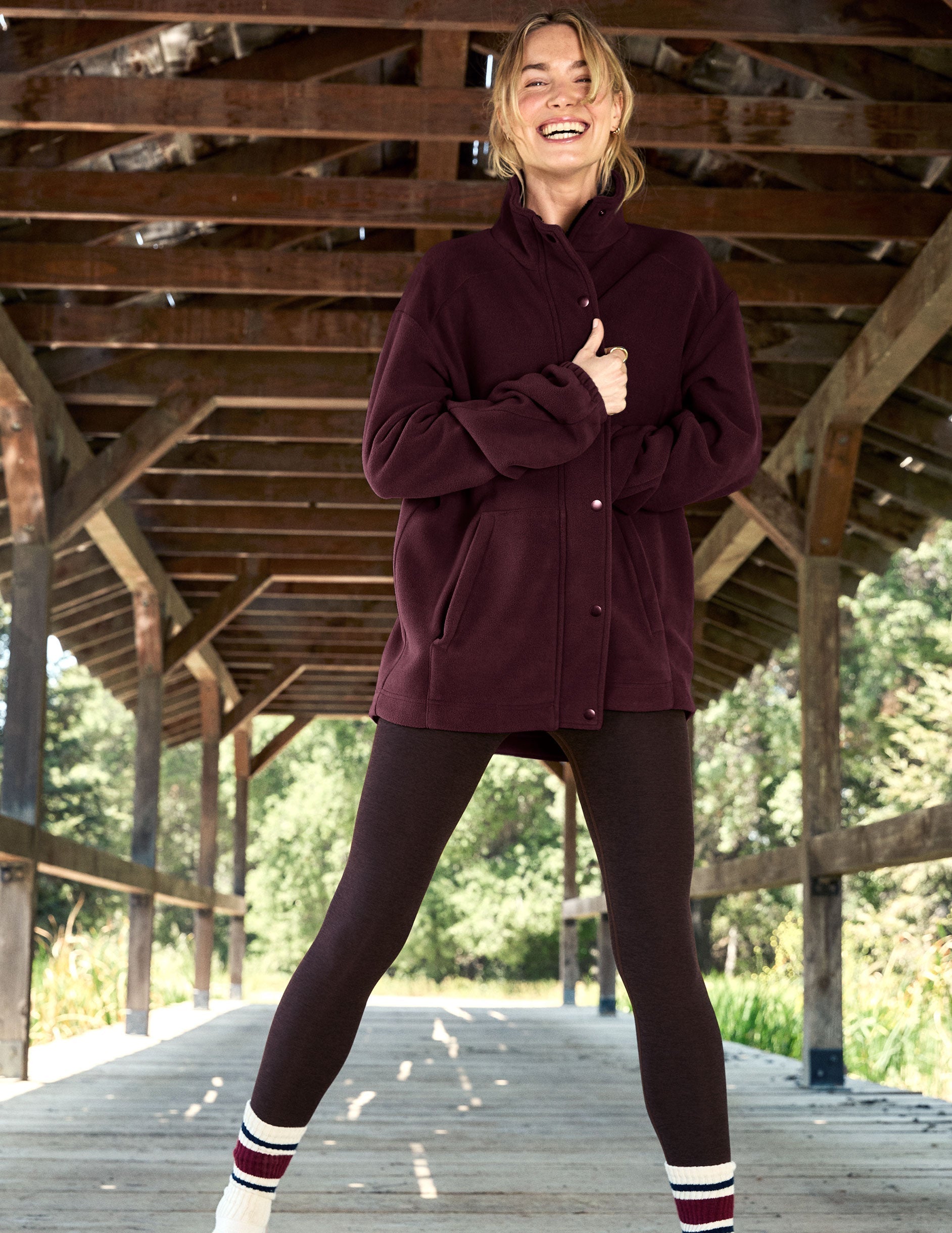 red fleece button up jacket with a full front zip and snap closures and pockets.