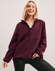 red fleece quarter zip jacket with a kangaroo pocket.