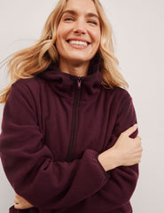 red fleece quarter zip jacket with a kangaroo pocket.