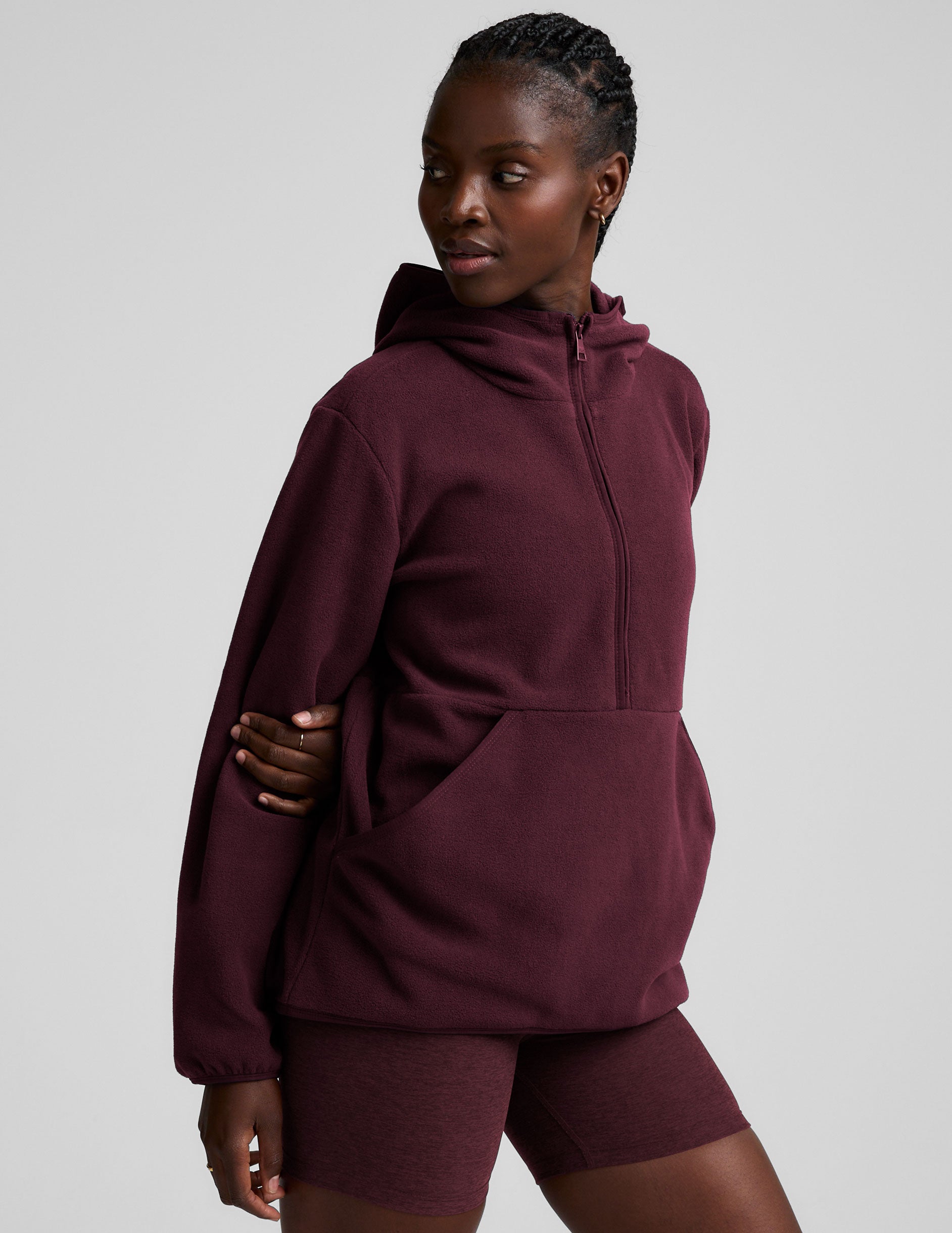 red fleece quarter zip jacket with a kangaroo pocket.