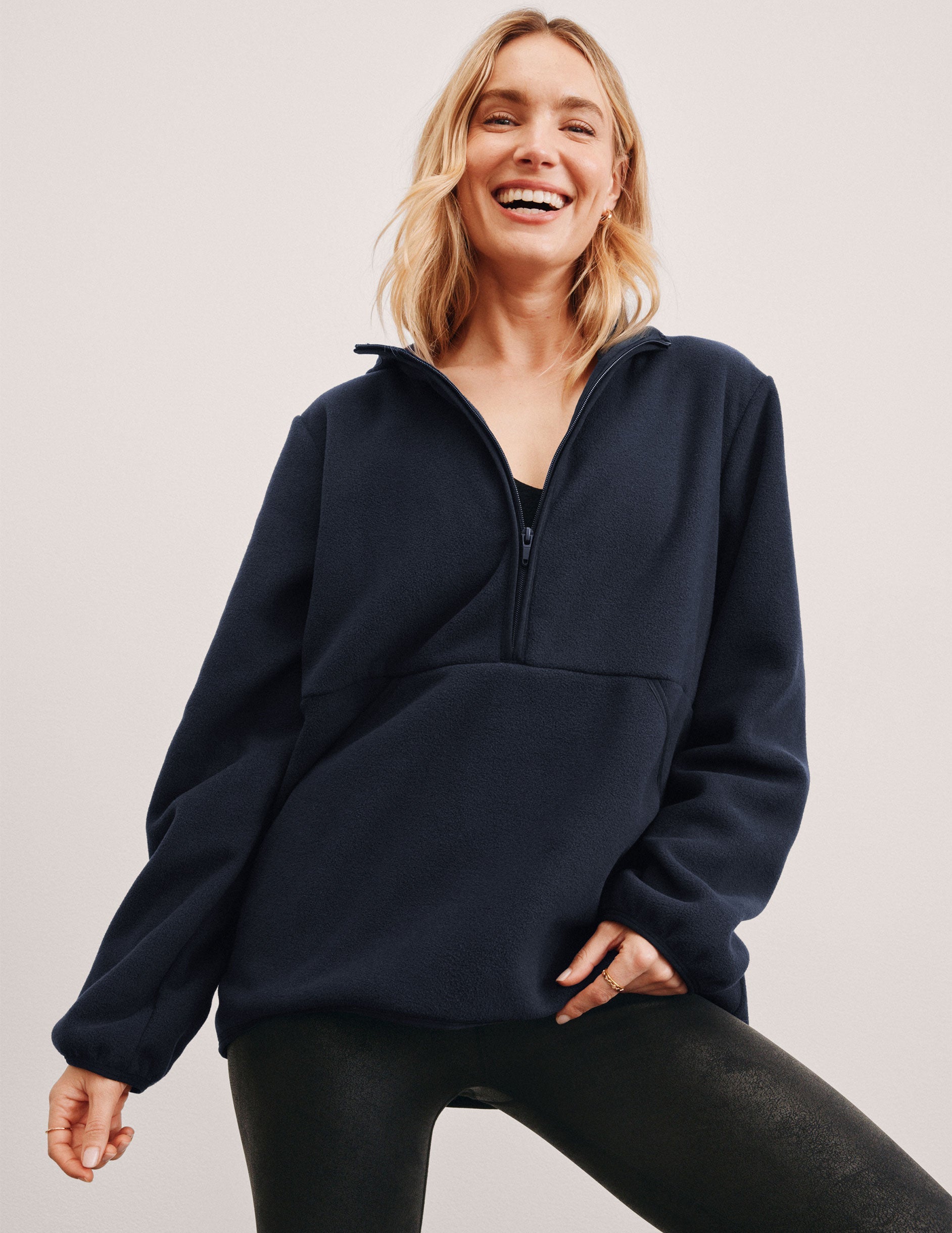 blue fleece quarter zip jacket with a kangaroo pocket.