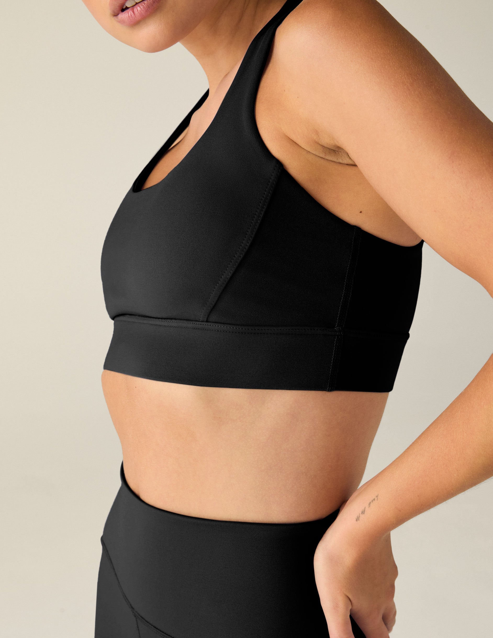 black scoop neck bra with crossover back detail.