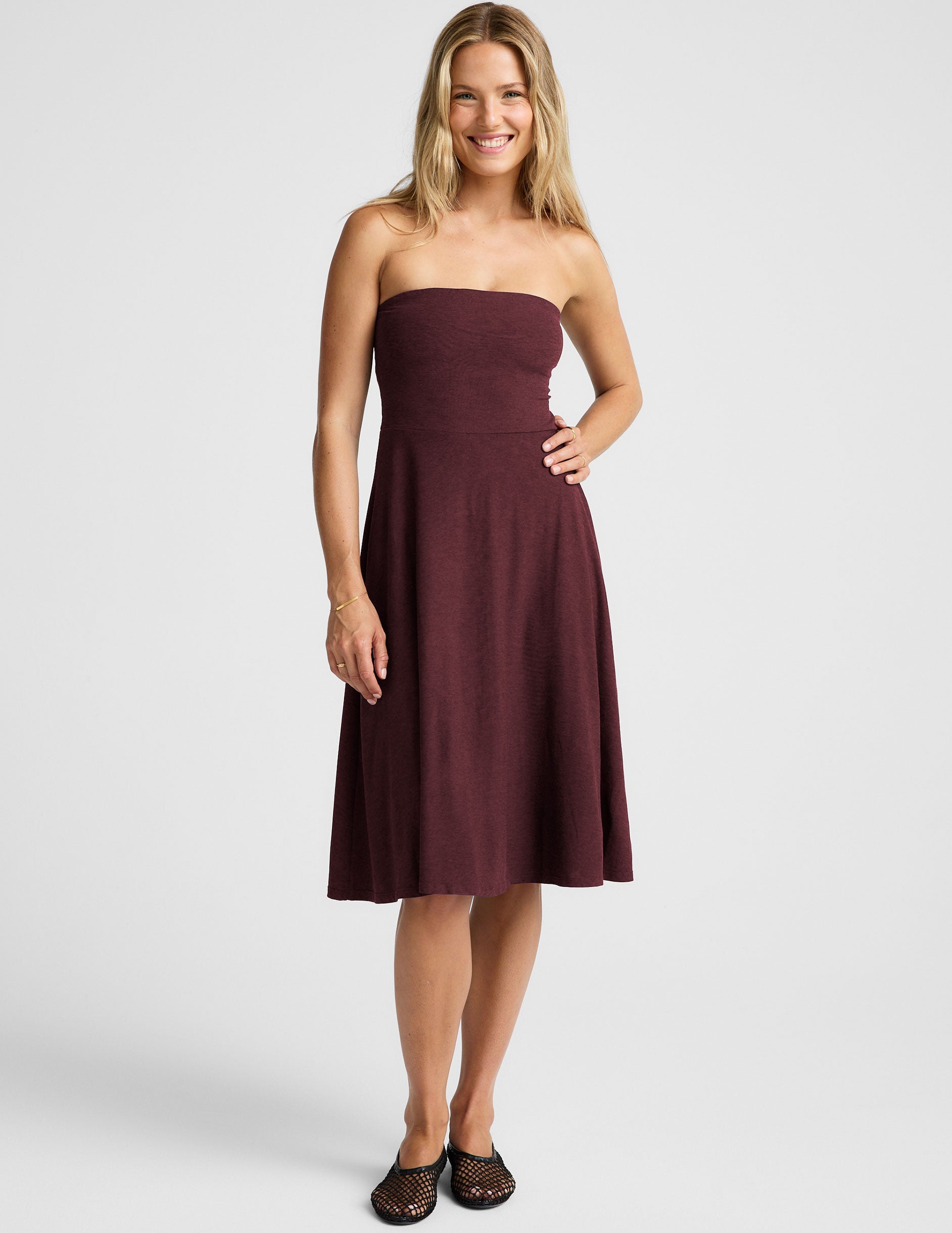 red strapless midi length dress with pockets.