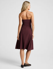 red strapless midi length dress with pockets.