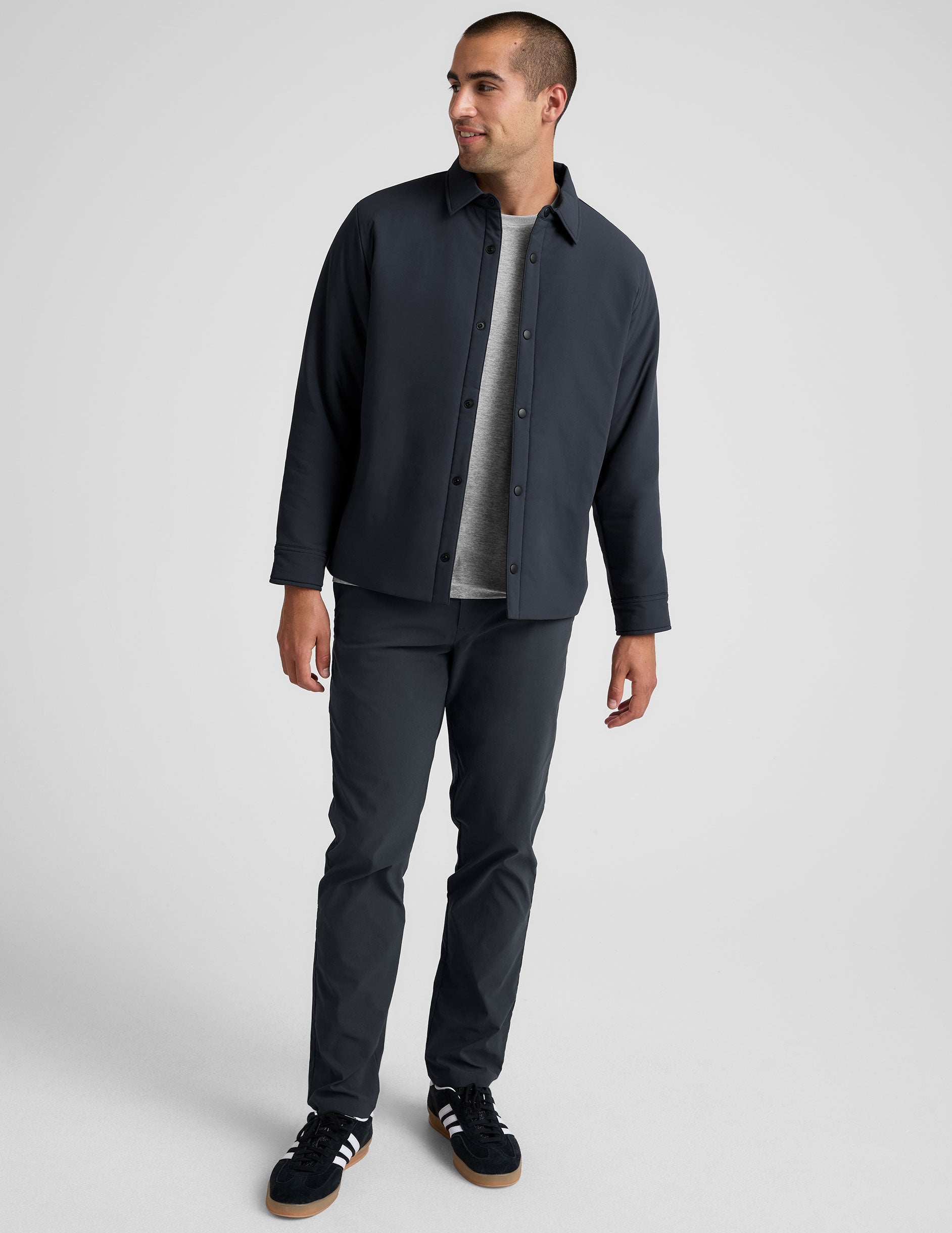 blue men's button up insulated jacket with a shirt collar and side seam invisible zipper pockets.