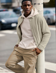 brown men's button up insulated jacket with a shirt collar and side seam invisible zipper pockets.