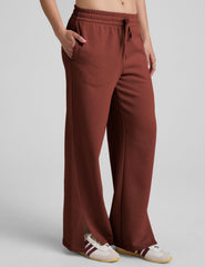 brown mid-rise wide leg sweatpants with side slits and a drawcord at waistband.