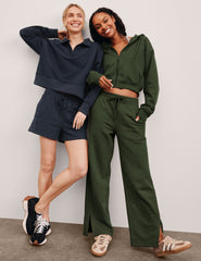 green mid-rise wide leg sweatpants with side slits and a drawcord at waistband.