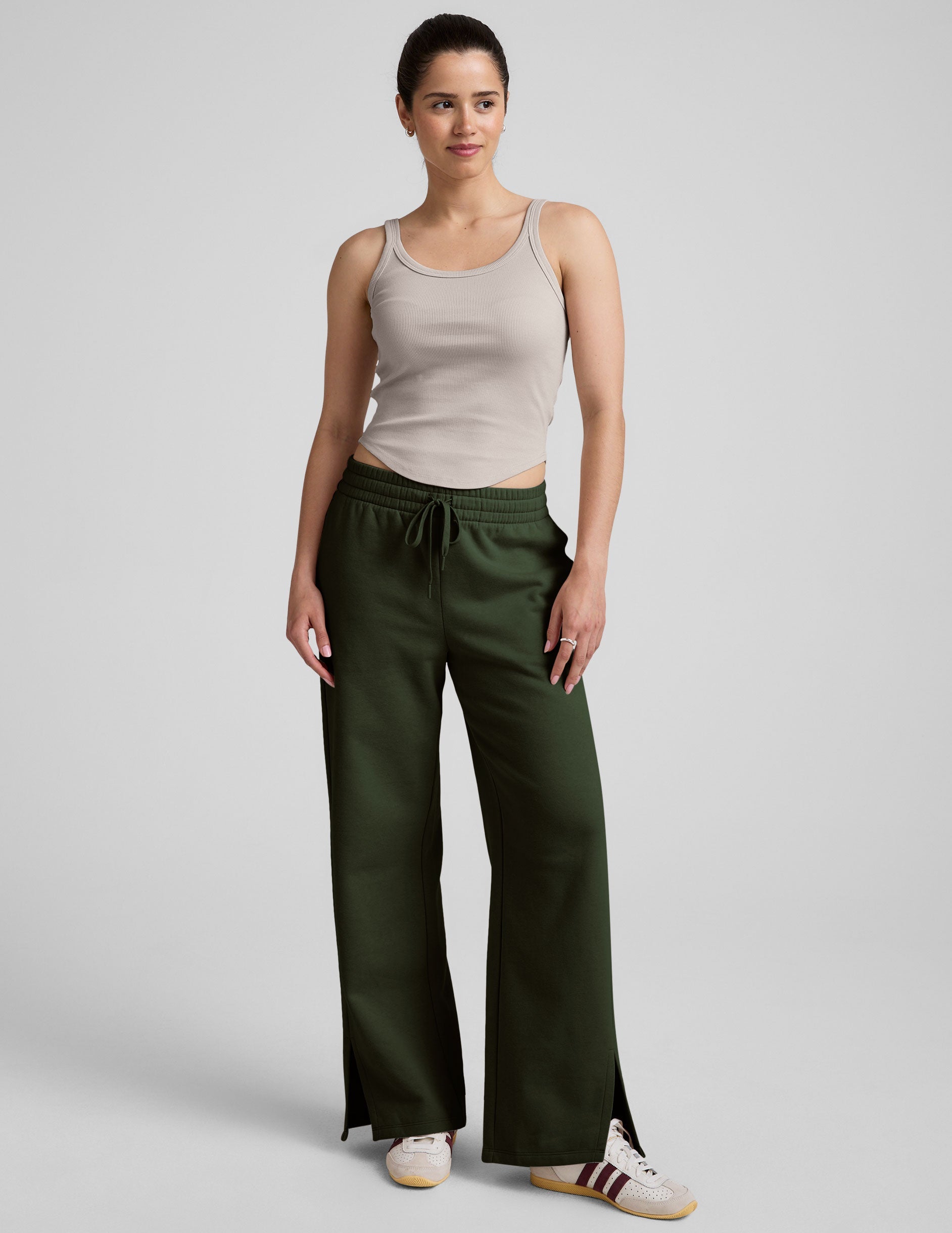 green mid-rise wide leg sweatpants with side slits and a drawcord at waistband.