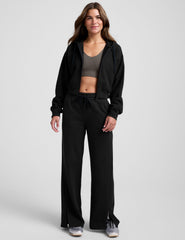 black fleece zip-up jacket with a drawstring hood.