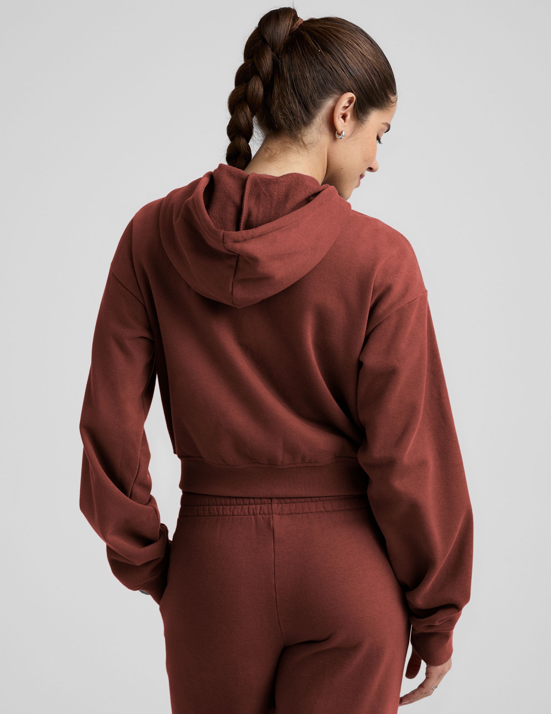 brown fleece zip-up jacket with a drawstring hood.