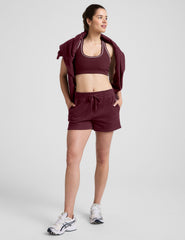 red mid rise sweat shorts with a 3.5" inseam and pockets. 