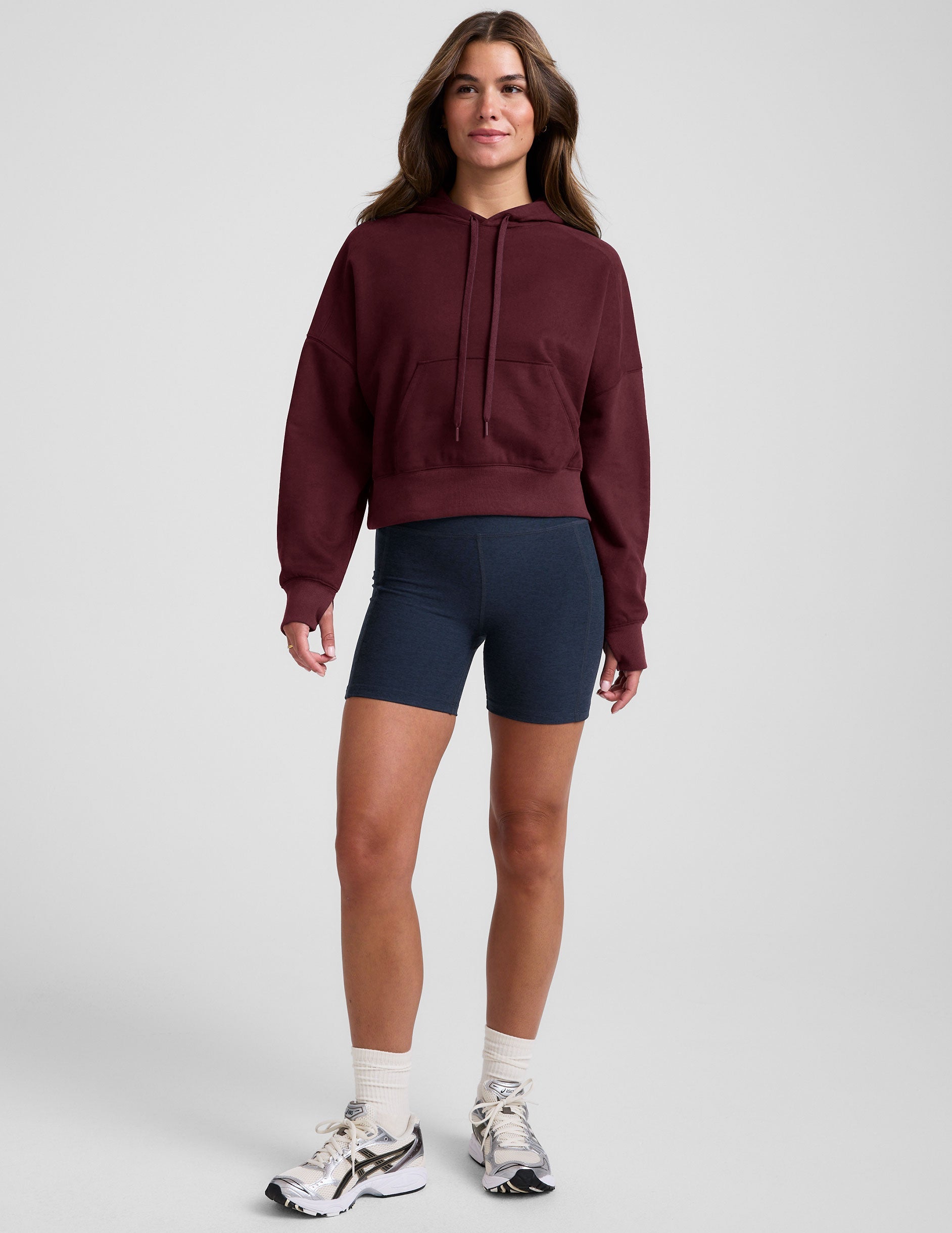 red cropped pullover with a hood with drawcord and a kangaroo pocket.
