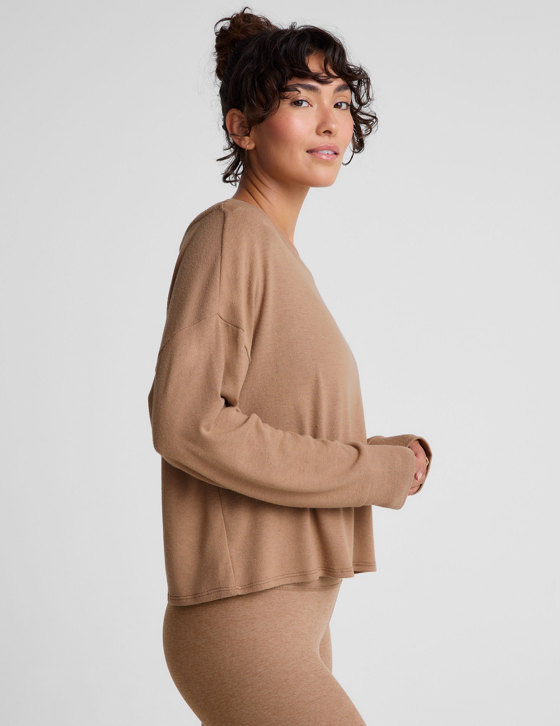 brown classic length long sleeve sweater with a wide off-the-shoulder neckline.