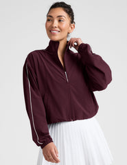 red zip-up jacket with white piping and pockets.