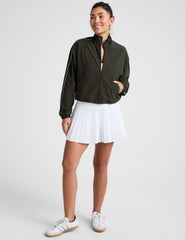 green zip-up jacket with white piping and pockets.
