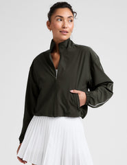 green zip-up jacket with white piping and pockets.