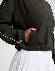 green zip-up jacket with white piping and pockets.