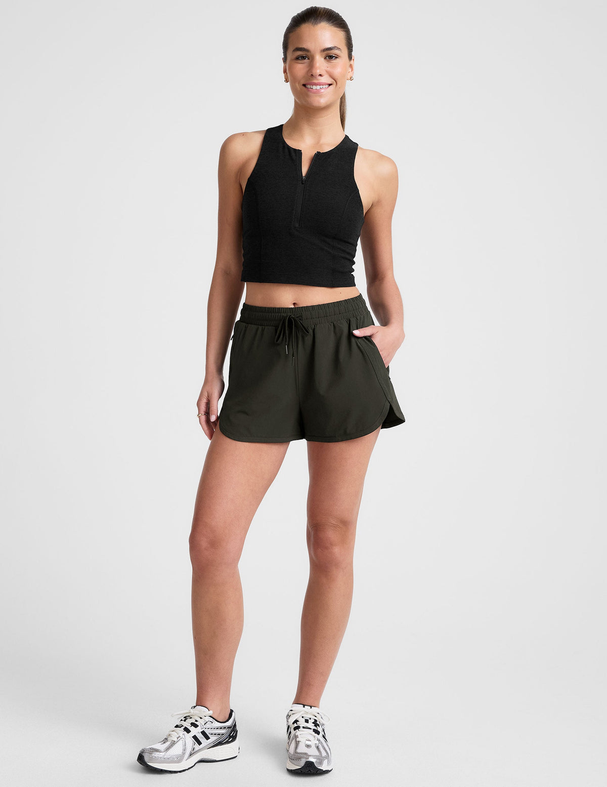 green 2.5" inseam shorts with side pockets and a drawstring at waistband. 
