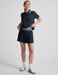 blue mini length pleated skirt with an exposed stripped elastic waistband​ and 
internal performance shorts with pockets​. 