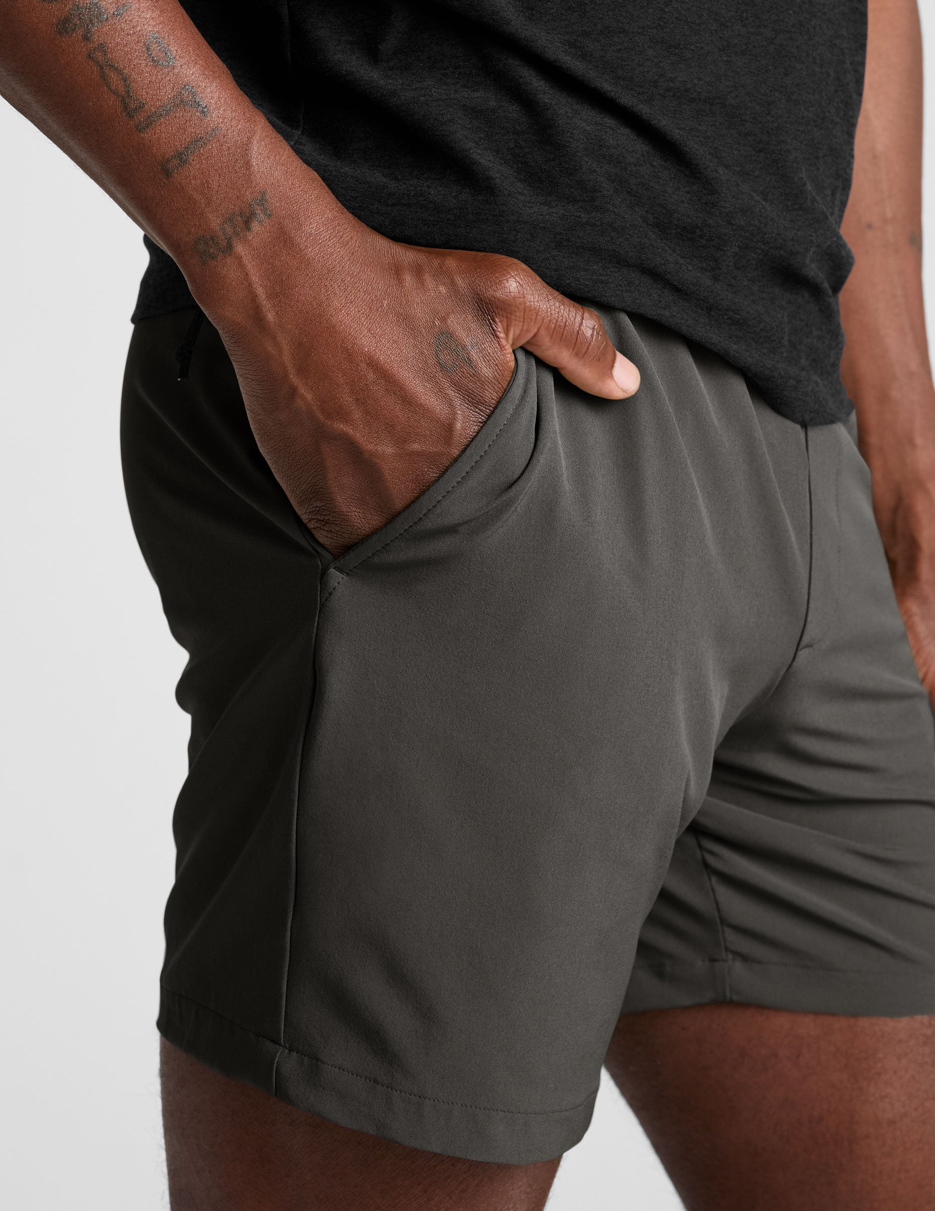 man wearing a long sleeve and graphite shorts on a white background.