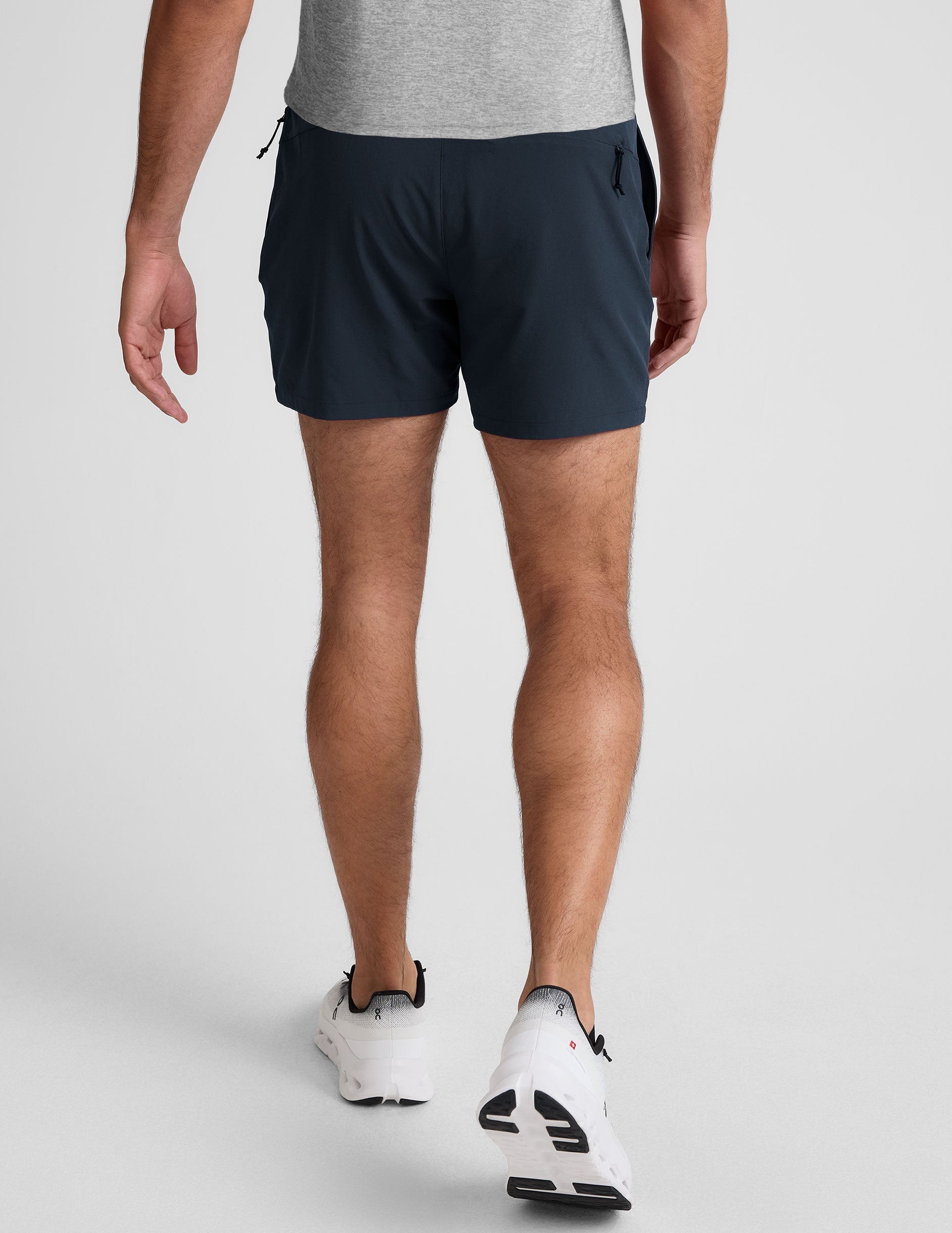 navy t-shirt and navy 5" shorts on a plain background. 