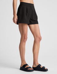 black high-waisted trouser shorts.