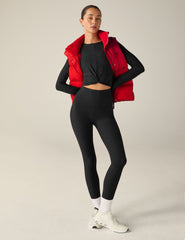 red button-up puffer vest with pockets.