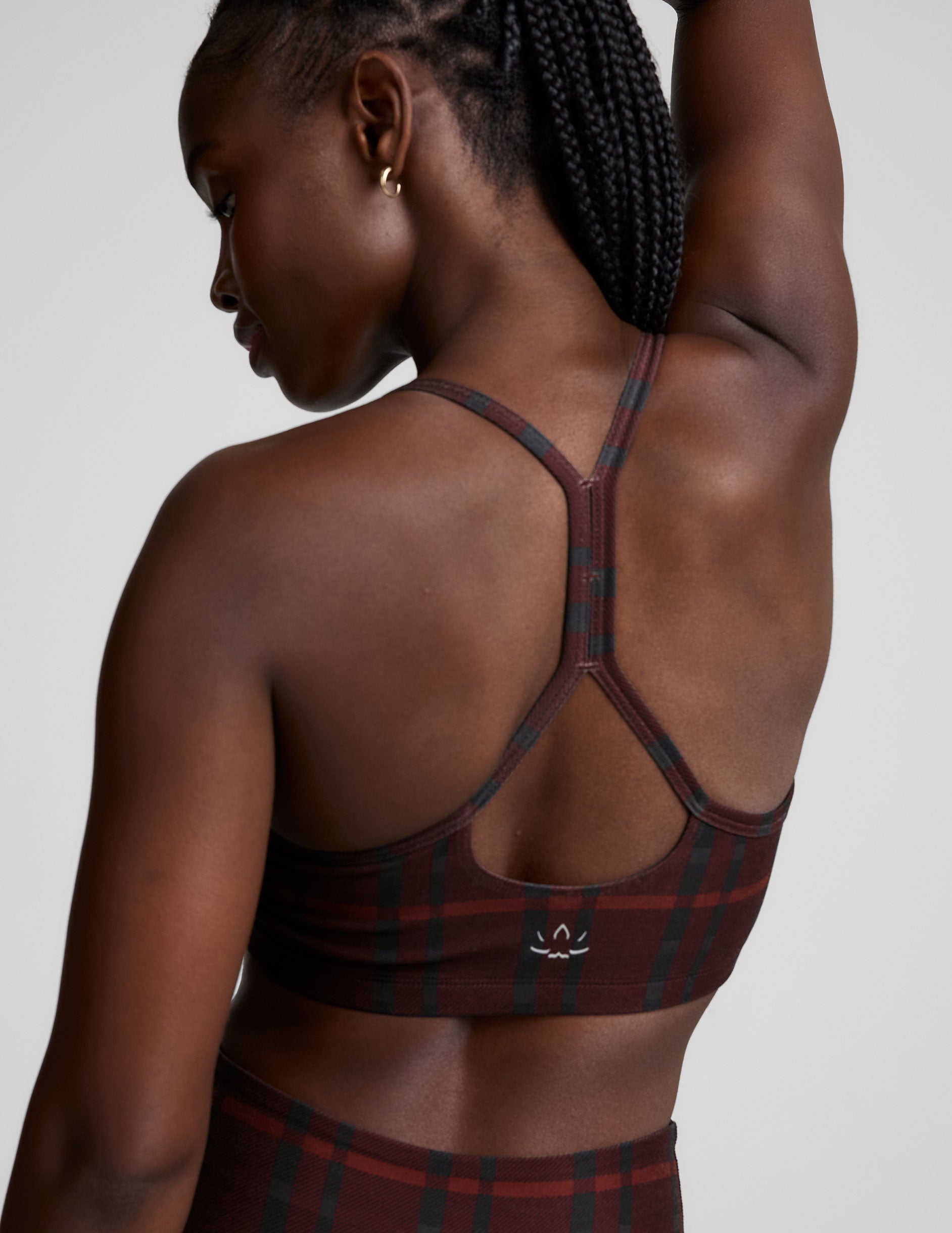 red racerback style bra with a plaid print and thin straps.
