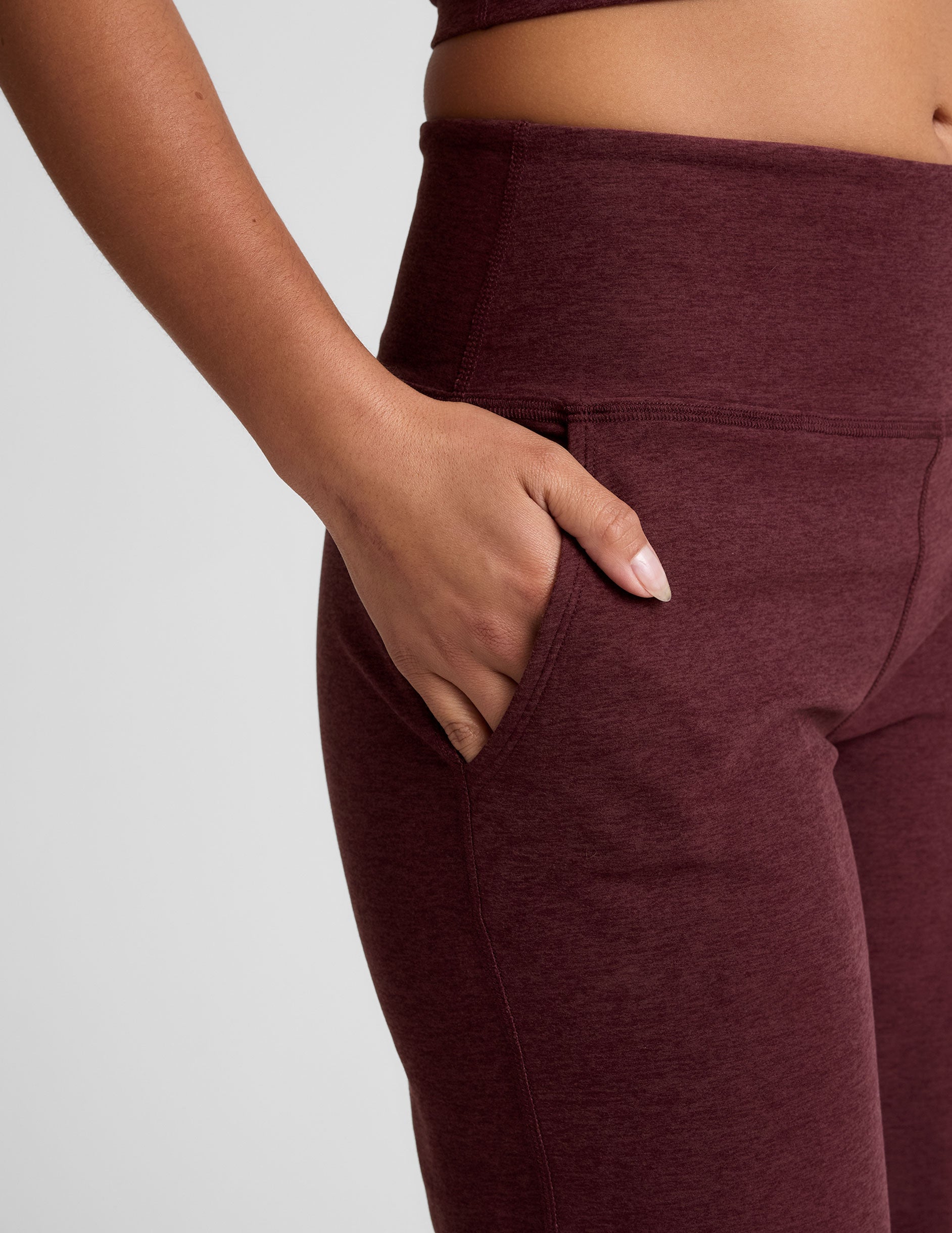 model is wearing red mid-rise wide leg pants with pockets.