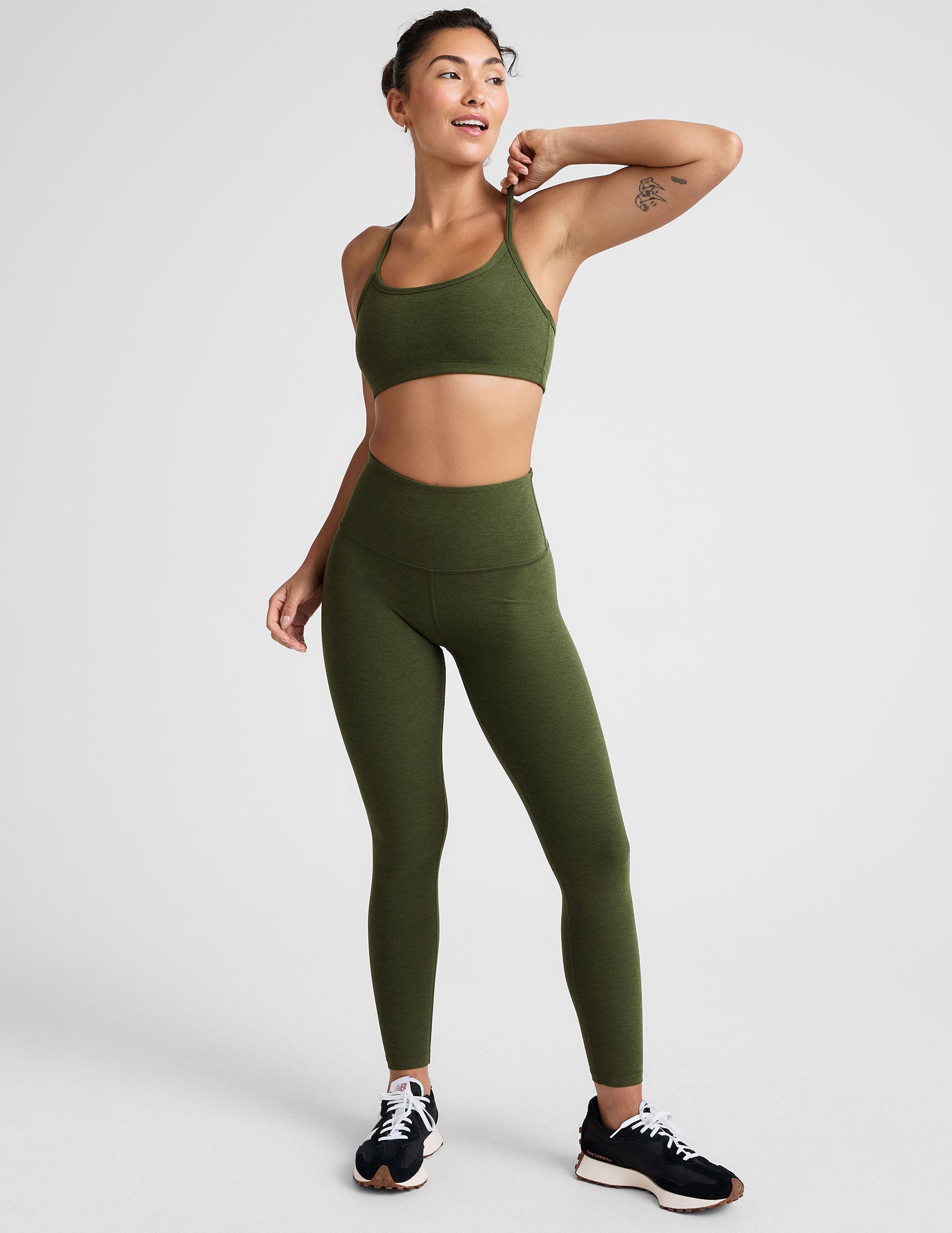 green high-waisted midi length leggings.