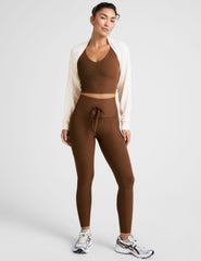 brown high-waisted midi length leggings with a drawstring at waistband and side pockets.