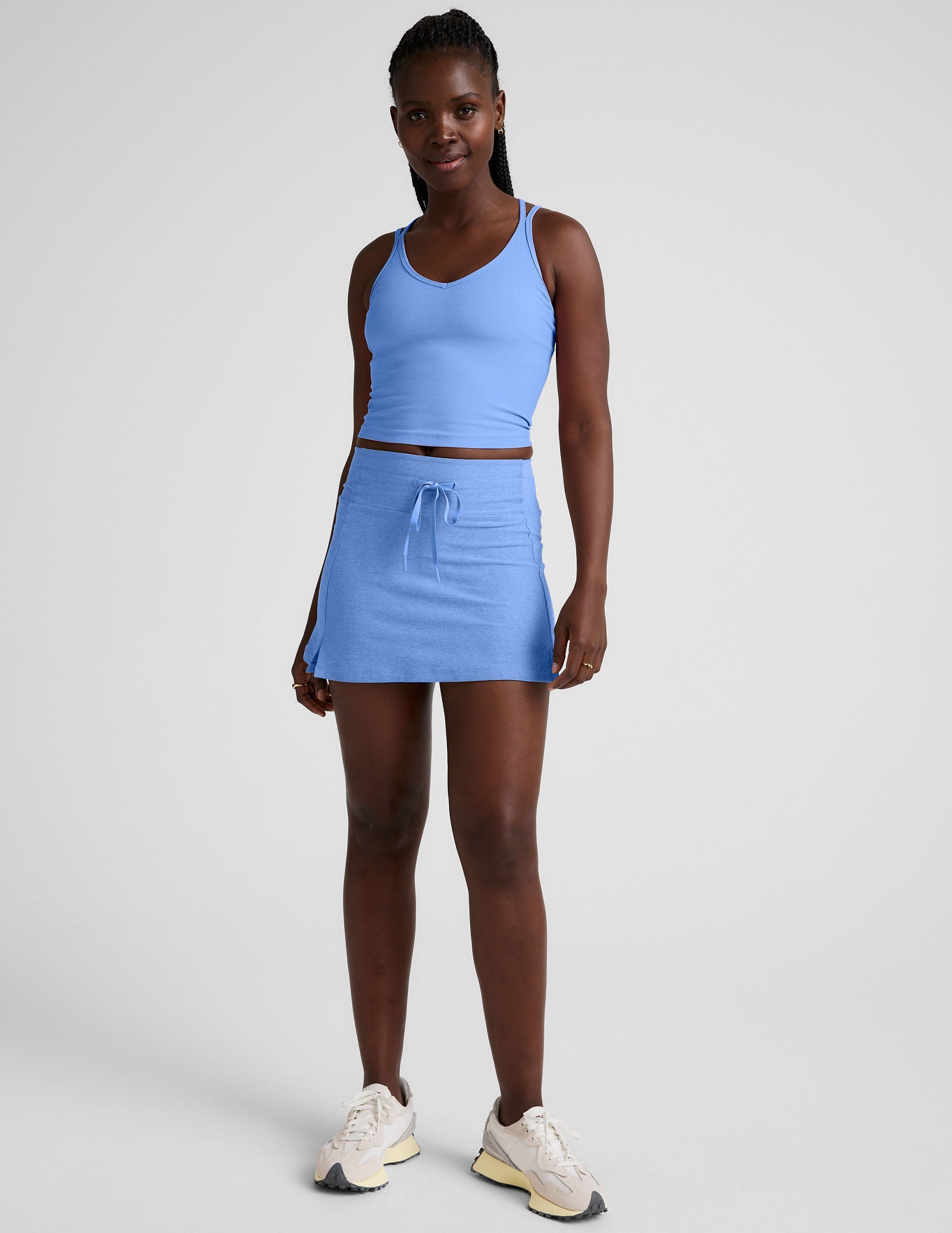 blue mini active skirt with a drawstring at waistband and built in shorts with pockets.