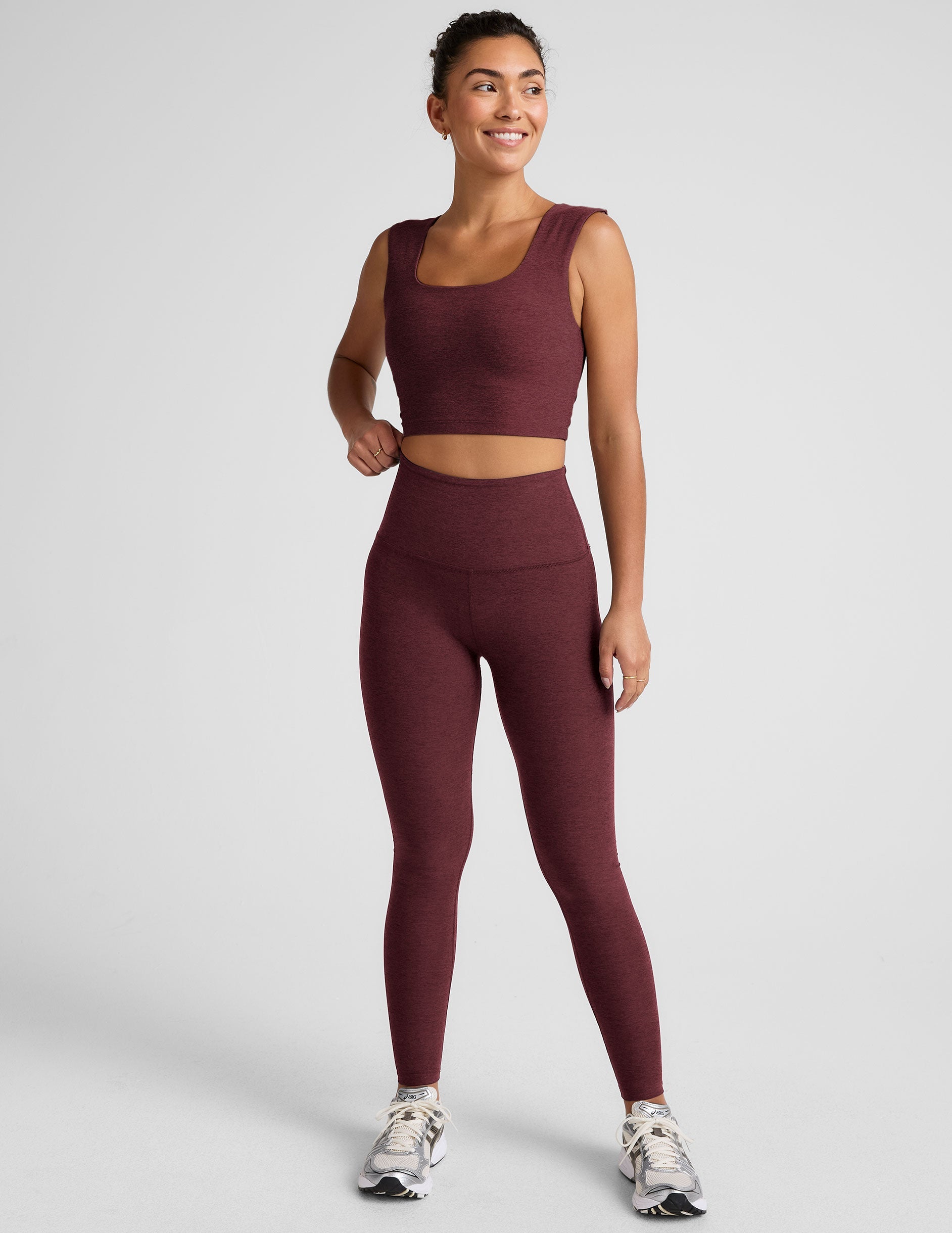 model is wearing a cropped square neck tank with thick straps.