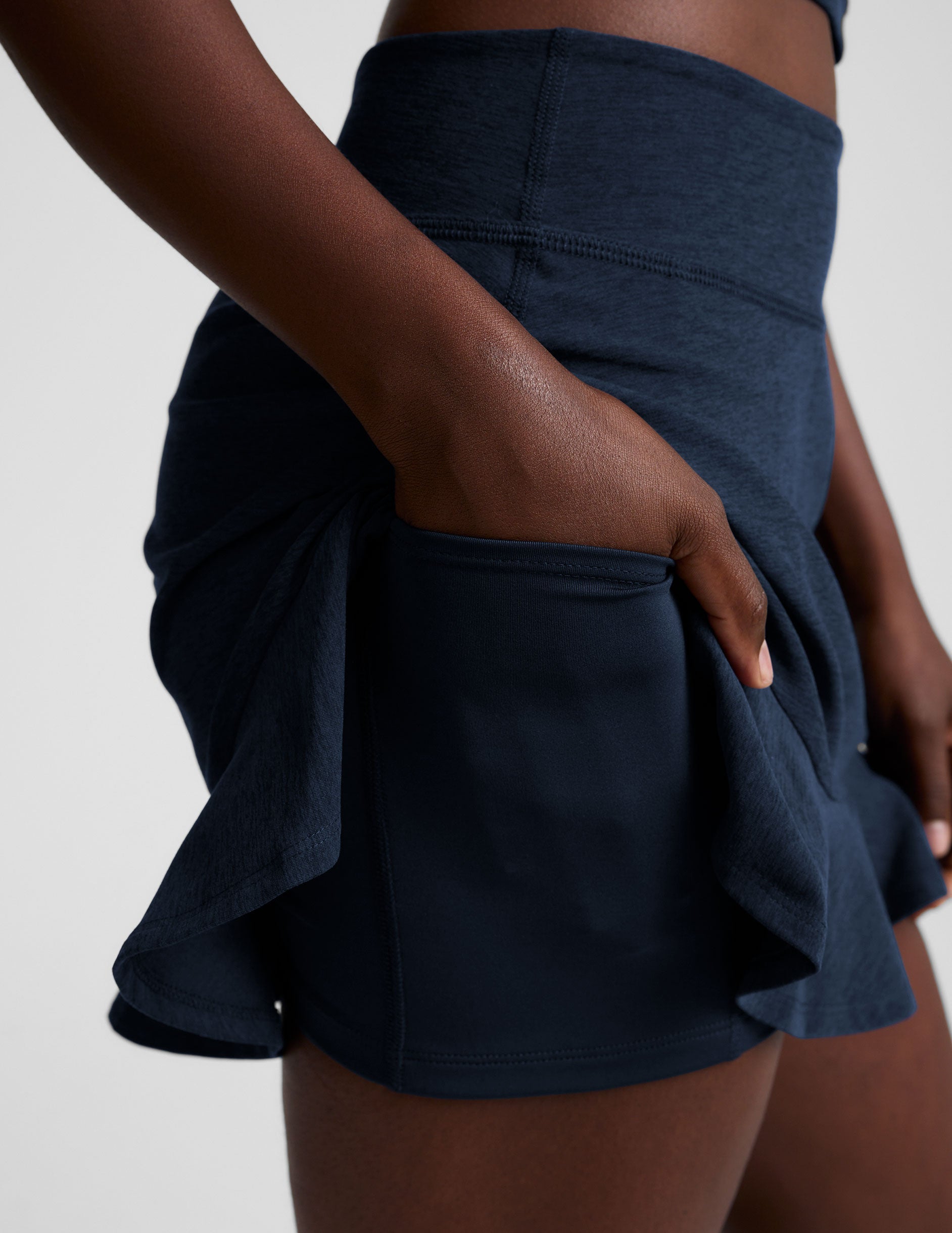 blue high-waisted skirt with a ruffle hem and built-in shorts with pockets.