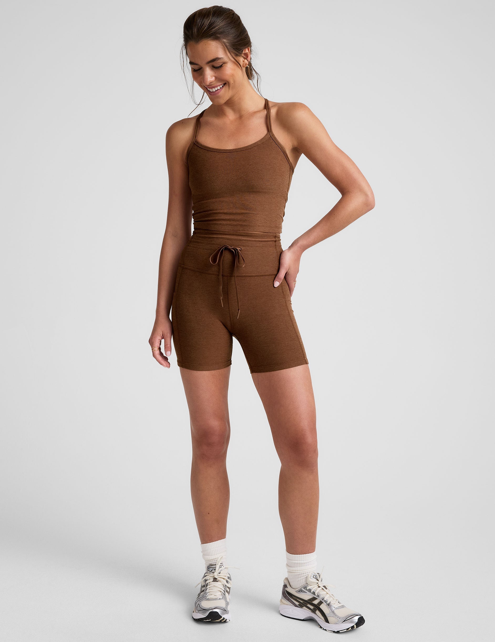 brown high-waisted 5" inseam biker shorts with a drawstring at waistband and side pockets. 