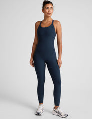 blue midi length jumpsuit with cross straps on back.