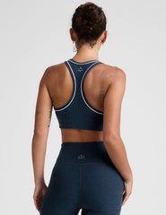 blue scoop neck racerback bra with white contrast trim.