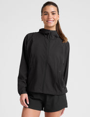 model wearing a black jacket and shorts on a light gray background.